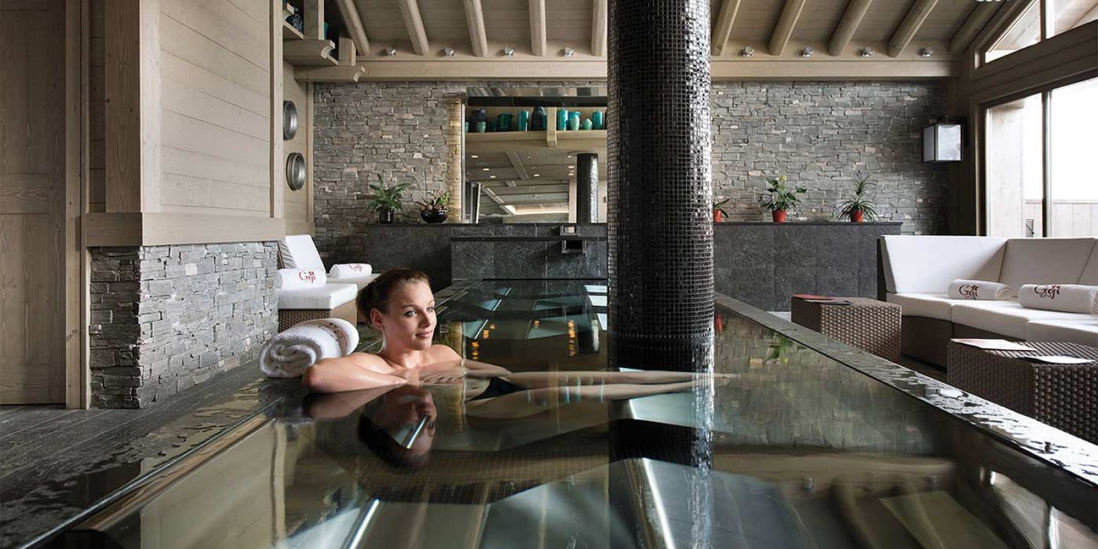 Hotel Le K2 Palace Courchevel Les 3 Vallees Frankrijk wintersport skivakantie luxe Spa welness jacuzzi dame pilaar loungebank hockers houten balken houten plafond ramen