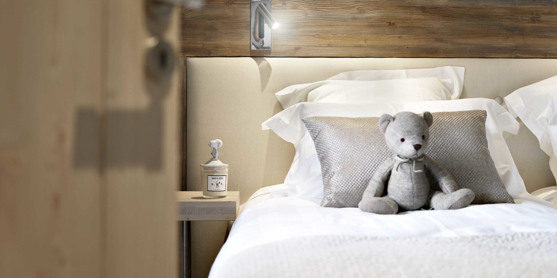 MGM Residence Les Chalets Elena Les Houches Chamonix Mont Blanc Frankrijk wintersport skivakantie luxe slaapkamer 2-persoonsbed hoofdbord grijs kussen beertje nachtlampje hout