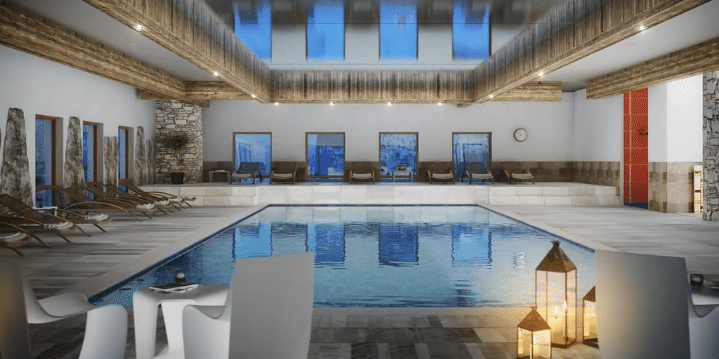 MGM Residence Alexane Samoens Le Grand Massif Frankrijk wintersport skivakantie luxe zwembad ligstoelen windlichten grote spiegel zitje tafel stoelen zwemmen ontspannen relaxen genieten