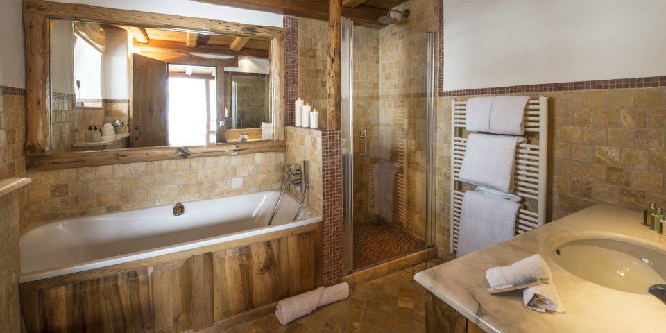 Chalet Le Chardon Val d'Isere Tignes-Val d'Isere Frankrijk wintersport skivakantie luxe badkamer bad douche handdoekenrek handdoeken wastafel houten balken