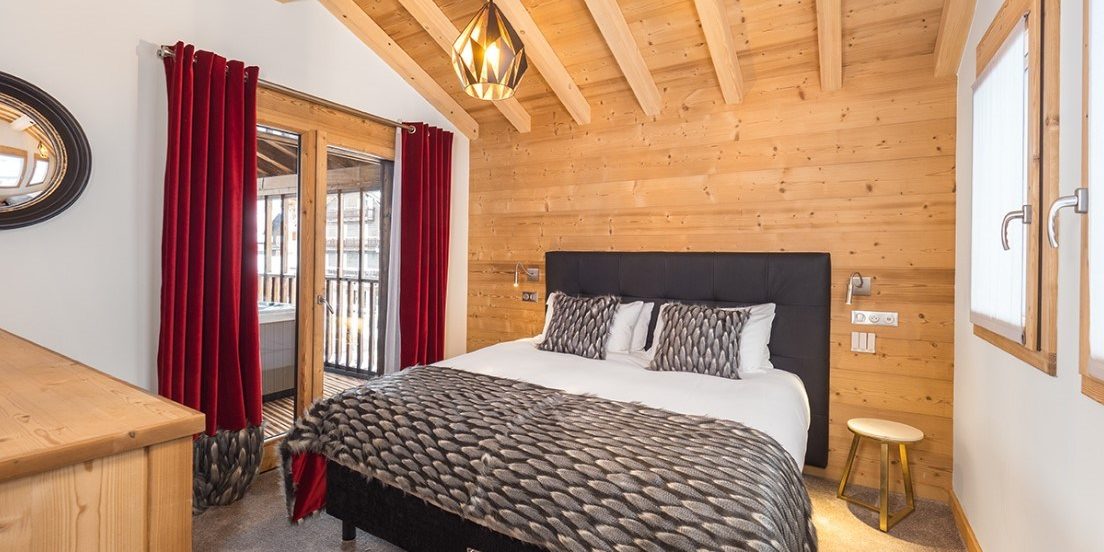 Colibri Penthouse Morzine Les Portes du Soleil Frankrijk wintersport skivakantie luxe slaapkamer 2-persoonsbed bedsprei kast raam houten balken